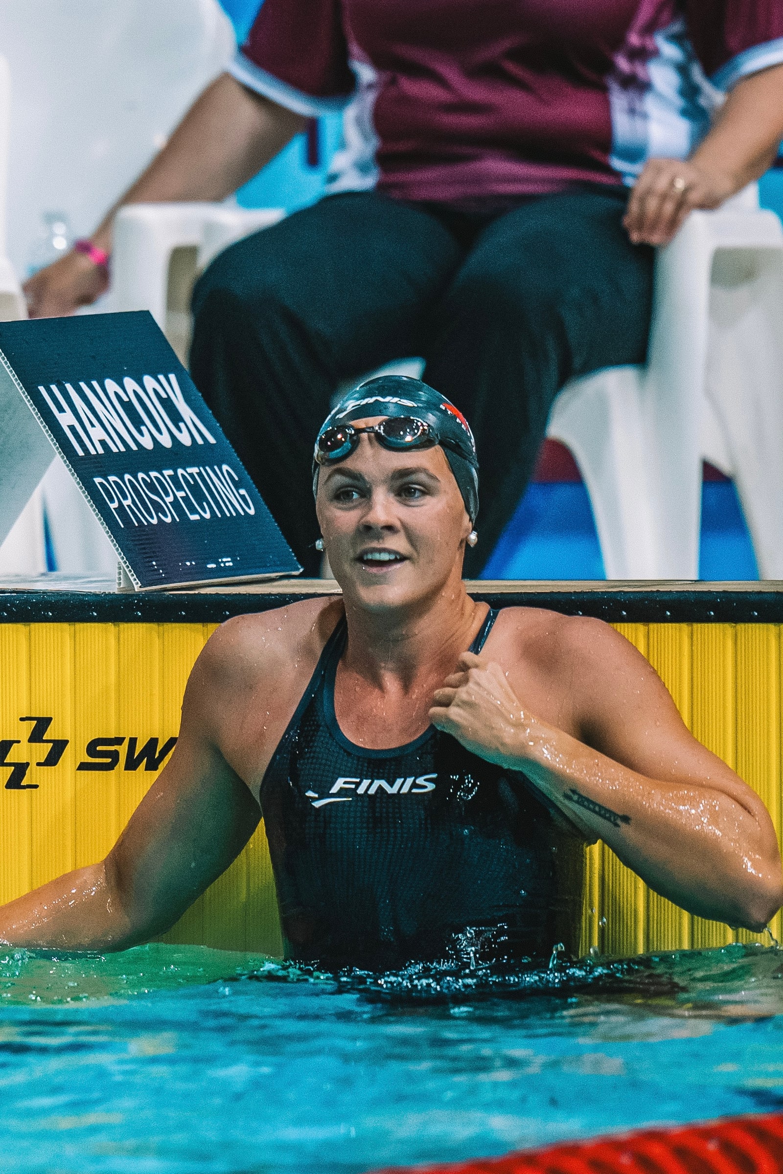 Shayna Jack in the pool wearing a FINIS cap and racing suit.