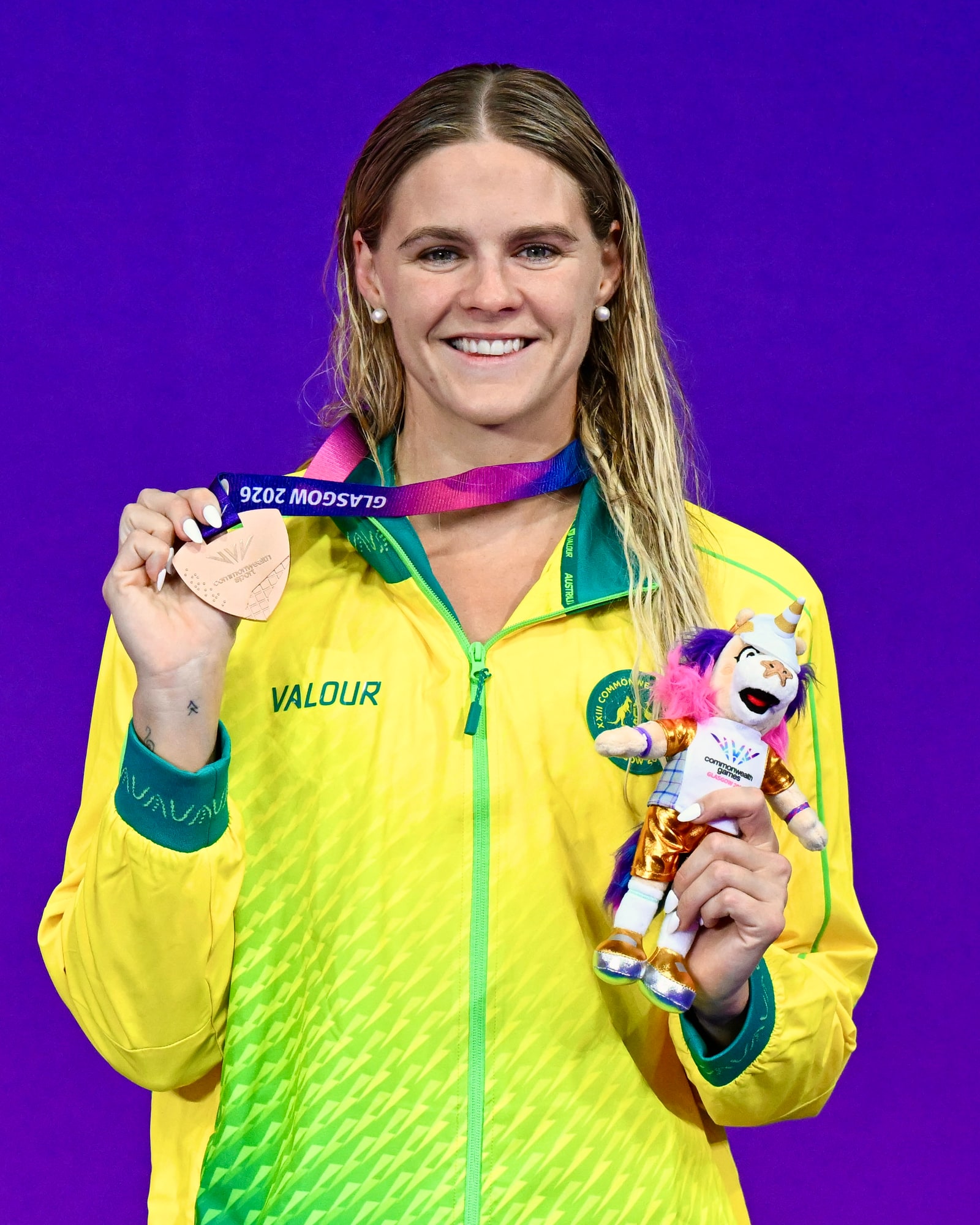 Shayna Jack in Australian team kit holding her Commonwealth Games medal.