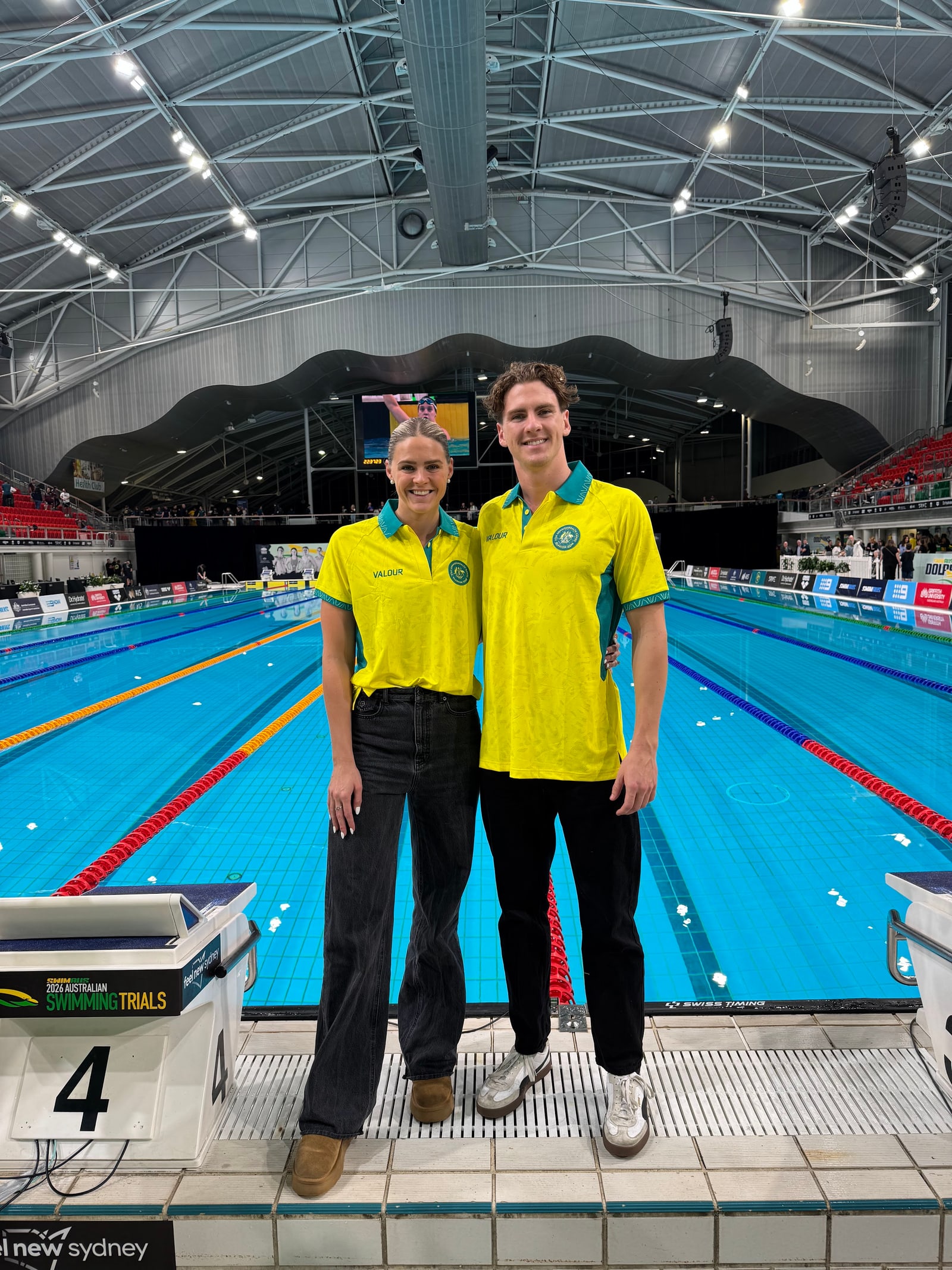 Shayna Jack and her brother Jamie Jack in Australian team uniforms on the pool deck.